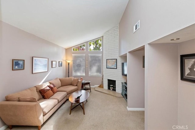 living room featuring vaulted ceiling, light carpet, and a fireplace