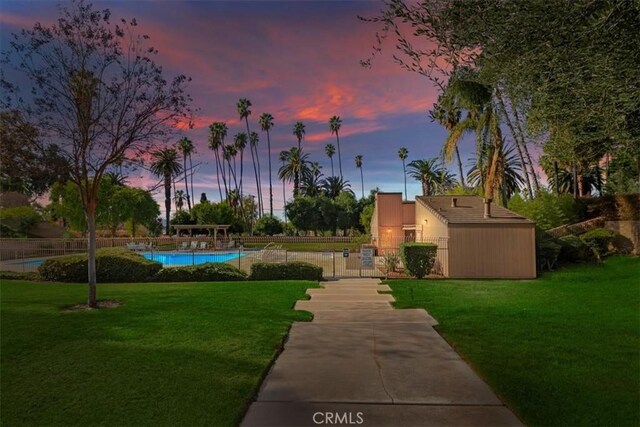 view of community with a yard and a swimming pool