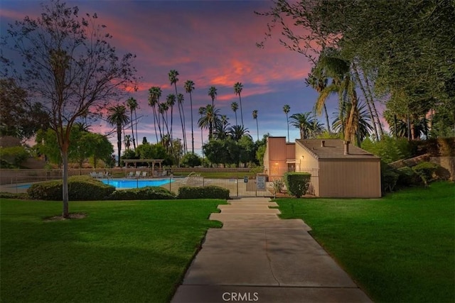 view of community featuring a pool and a lawn