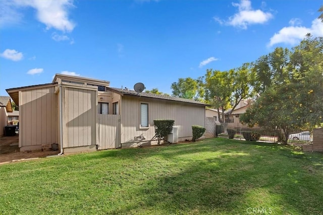 rear view of property featuring a lawn