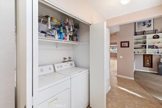 laundry room featuring light carpet and washer and dryer