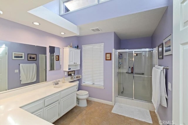 bathroom featuring a shower with shower door, tile patterned floors, vanity, and toilet