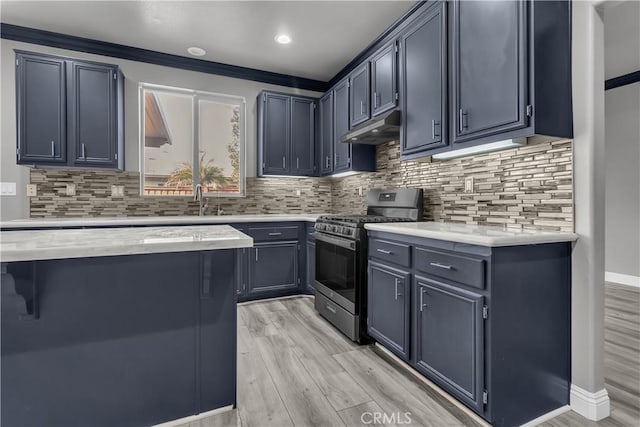 kitchen with tasteful backsplash, sink, light wood-type flooring, stainless steel range with gas cooktop, and crown molding