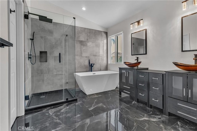 bathroom featuring lofted ceiling, vanity, and separate shower and tub