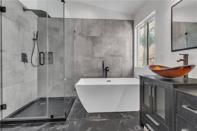 bathroom featuring vanity, separate shower and tub, and vaulted ceiling