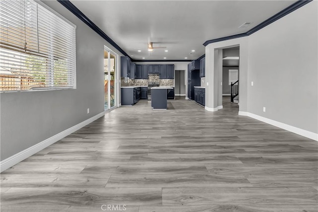 unfurnished living room featuring crown molding