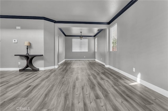 unfurnished living room featuring ornamental molding, a chandelier, and light wood-type flooring