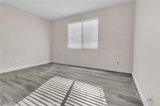 unfurnished room with light hardwood / wood-style floors