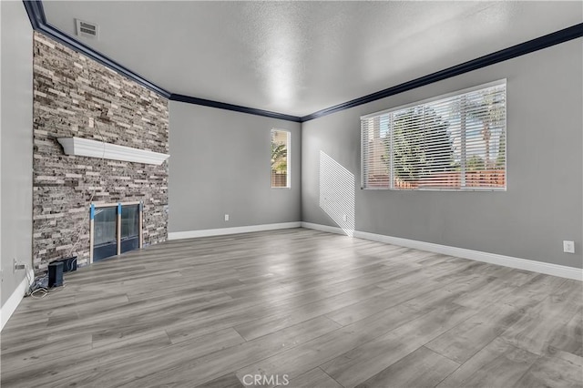 unfurnished living room with ornamental molding and light hardwood / wood-style floors