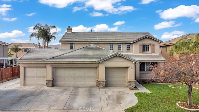 front of property featuring a garage and a front yard