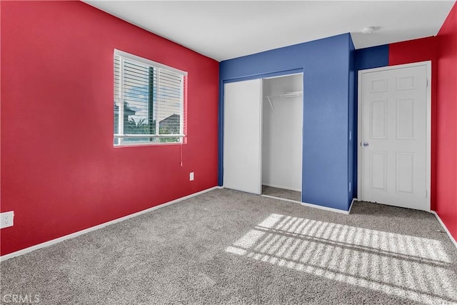 unfurnished bedroom featuring carpet and a closet