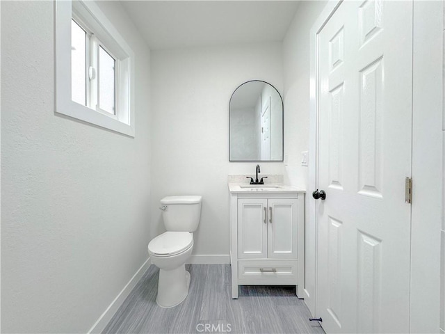 bathroom featuring toilet and vanity