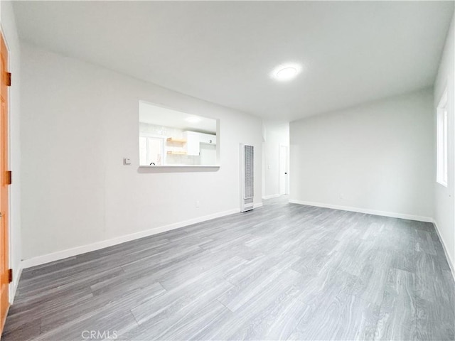 spare room featuring wood-type flooring