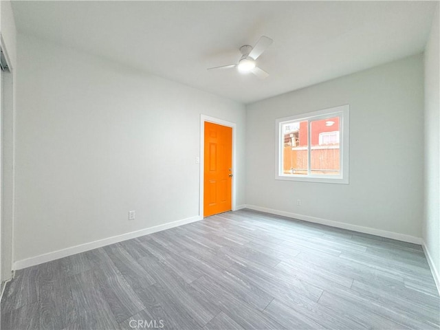 empty room featuring ceiling fan and hardwood / wood-style flooring