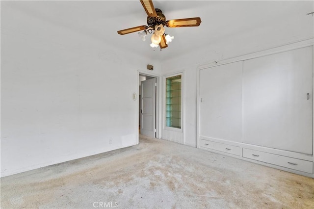 spare room featuring ceiling fan and light carpet