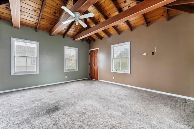 carpeted empty room featuring ceiling fan, vaulted ceiling with beams, and wooden ceiling