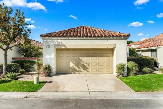 mediterranean / spanish home with a garage