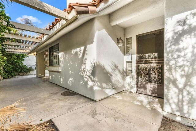 view of property exterior with a patio area