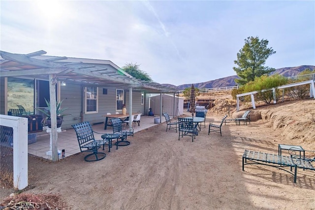 view of patio featuring a mountain view and a pergola