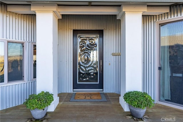 view of exterior entry with a porch