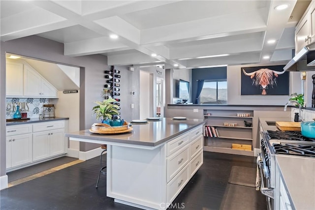 kitchen featuring white cabinetry, stainless steel stove, recessed lighting, and a sink