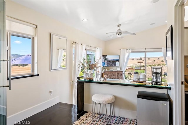 kitchen with a mountain view, stainless steel refrigerator, lofted ceiling, and ceiling fan