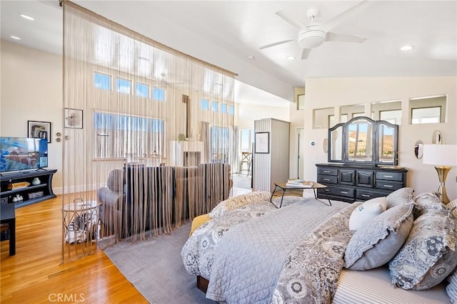 bedroom featuring hardwood / wood-style floors and high vaulted ceiling