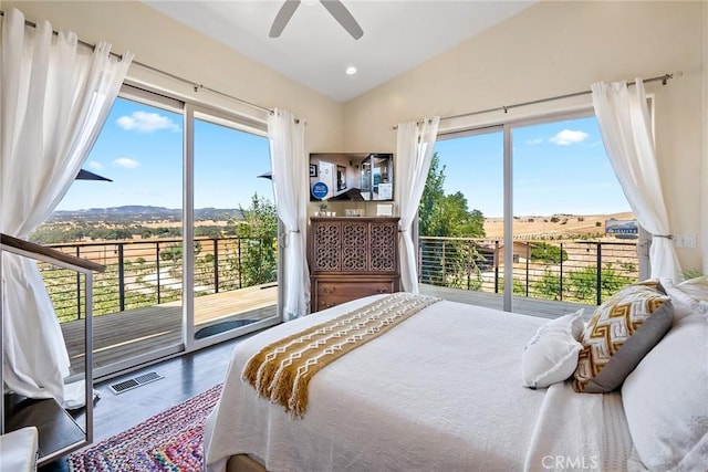 bedroom with access to exterior, vaulted ceiling, hardwood / wood-style floors, and ceiling fan