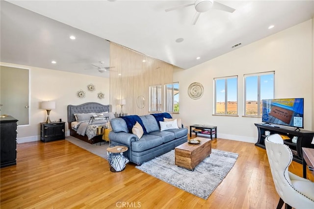bedroom with vaulted ceiling, multiple windows, visible vents, and light wood-type flooring