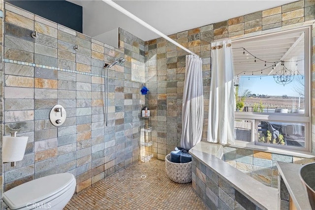 bathroom featuring toilet and a tile shower