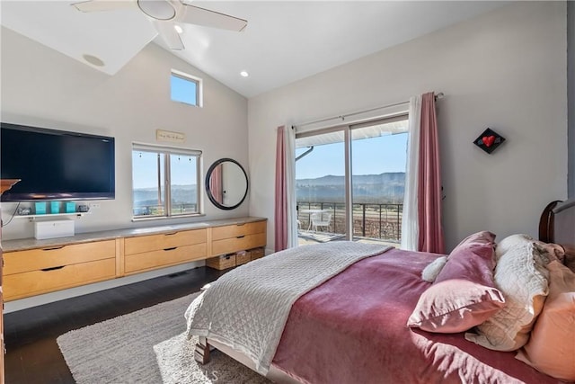 bedroom featuring access to exterior, vaulted ceiling, wood finished floors, a mountain view, and a ceiling fan