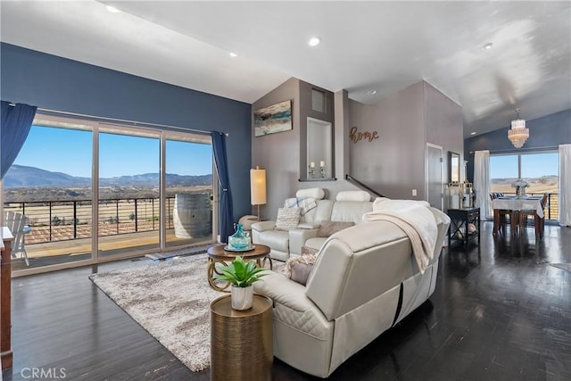 bedroom featuring lofted ceiling, a mountain view, multiple windows, and access to outside