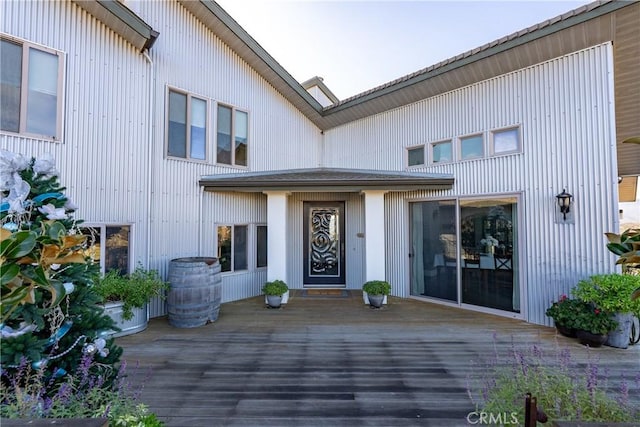 view of exterior entry with a deck