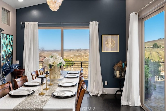 dining area with baseboards and wood finished floors