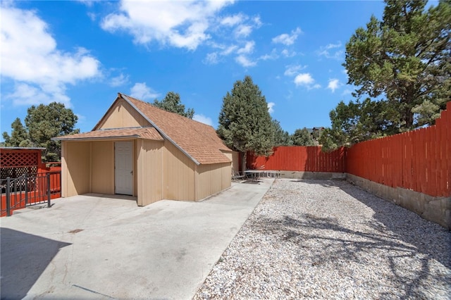 exterior space featuring a storage unit and a patio