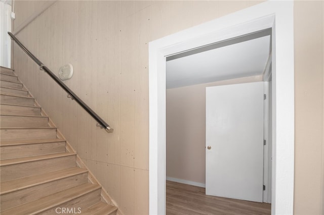 stairs featuring hardwood / wood-style floors