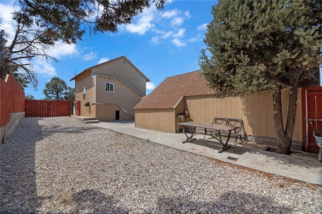 back of house with a patio area and an outdoor structure