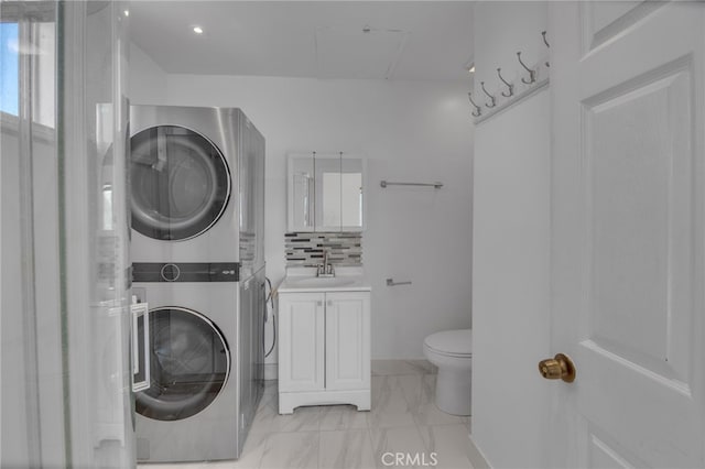 laundry room with sink and stacked washing maching and dryer