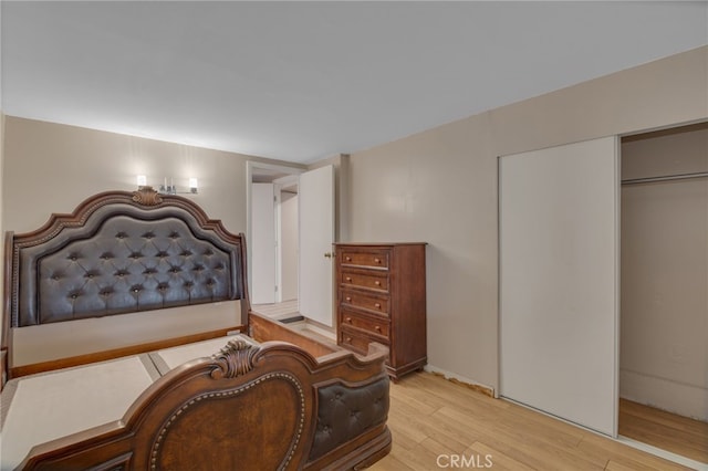 bedroom featuring light hardwood / wood-style floors and a closet