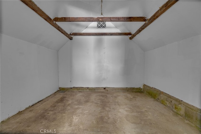 additional living space featuring concrete floors and lofted ceiling