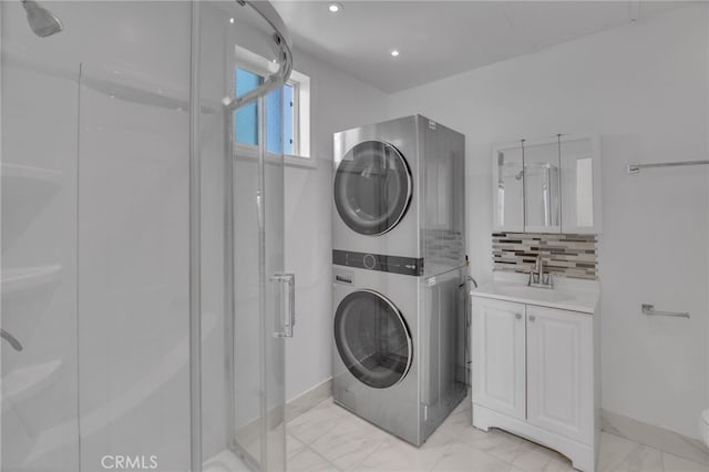 clothes washing area with stacked washer / dryer and sink