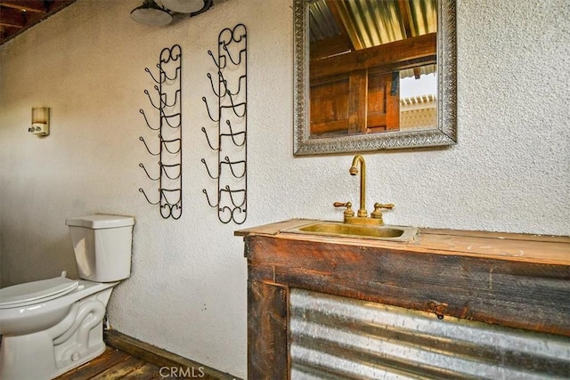 bathroom featuring toilet and vanity