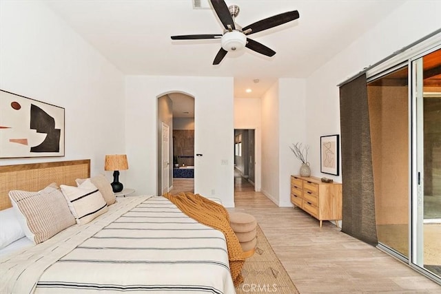 bedroom with ceiling fan, a closet, and light hardwood / wood-style flooring