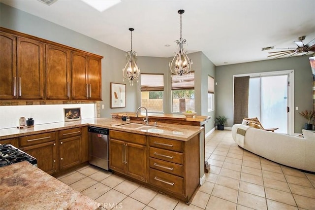 kitchen featuring dishwasher, sink, hanging light fixtures, kitchen peninsula, and light tile patterned flooring