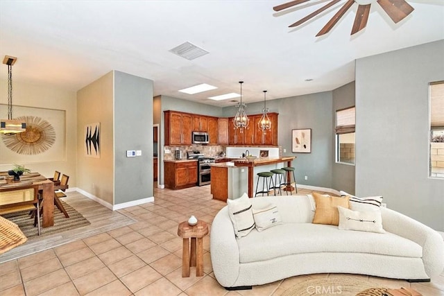 living room featuring ceiling fan and light tile patterned floors