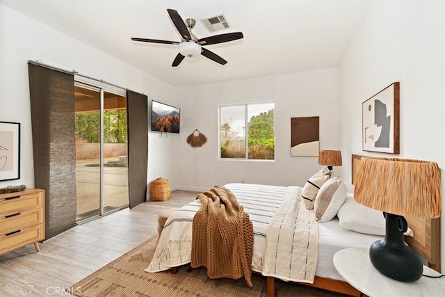 bedroom with access to outside, ceiling fan, and light hardwood / wood-style flooring