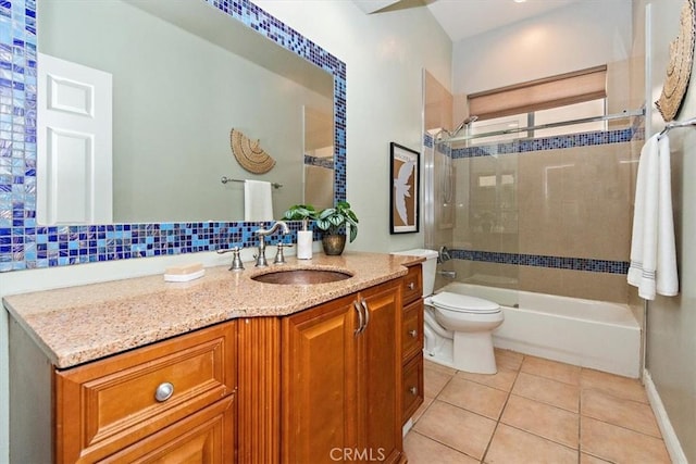 full bathroom featuring tiled shower / bath combo, tile patterned flooring, vanity, tasteful backsplash, and toilet