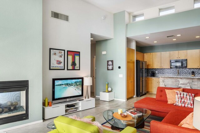 living room featuring a high ceiling