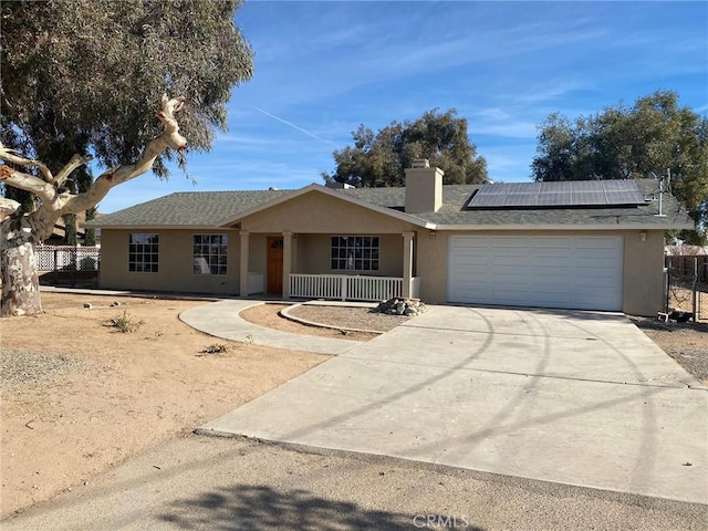 ranch-style home with solar panels and a garage