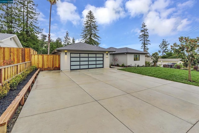 view of front of home with a garage and a front yard